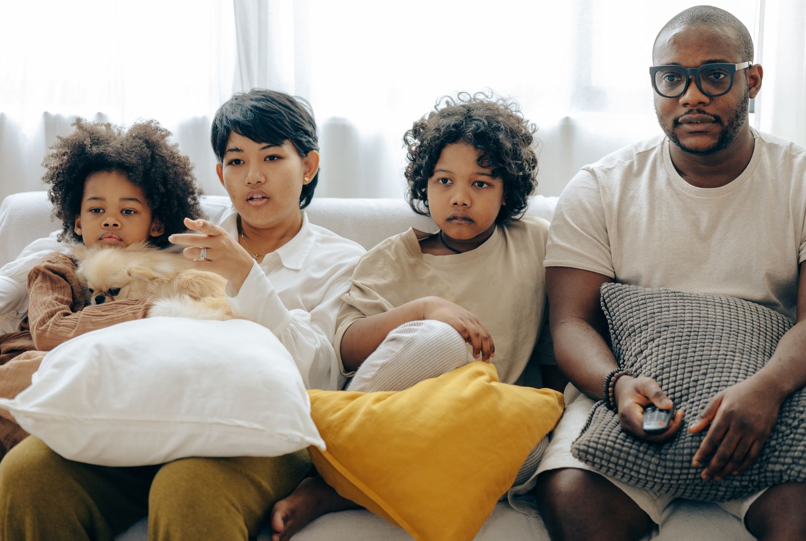 Family watching TV together on the sofa
