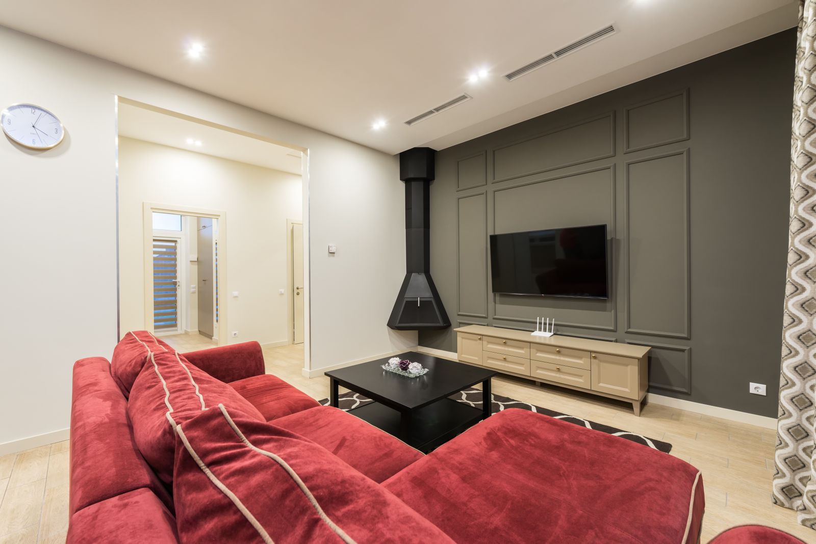 Living room with a fireplace and a wall-mounted TV